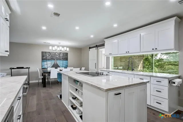 a view of a dining room with furniture wooden floor and a chandelier