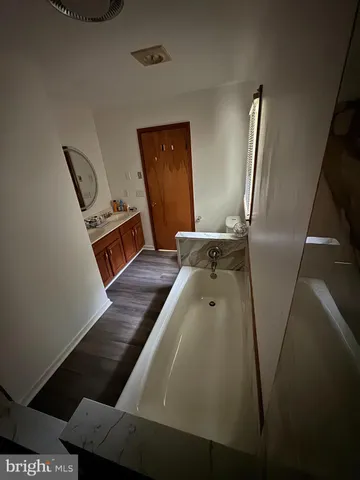 a bathroom with a toilet a sink and a window