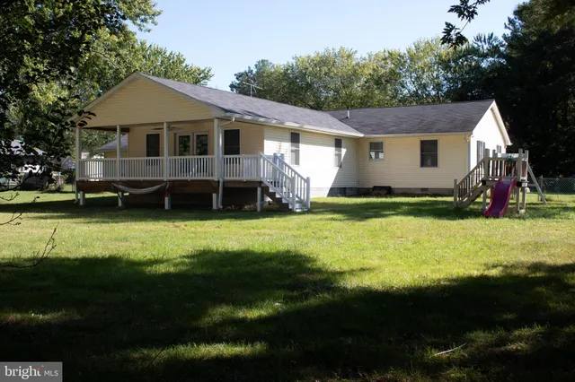 a view of a porch with wooden floor and outdoor space