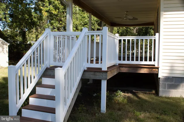 a view of a house with a yard and sitting area