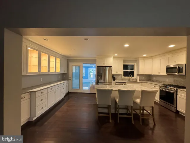 a large kitchen with a table and chairs in it