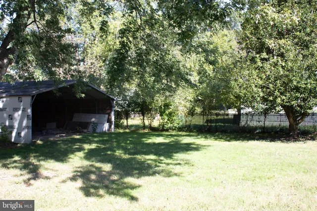 a view of a swimming pool with a yard