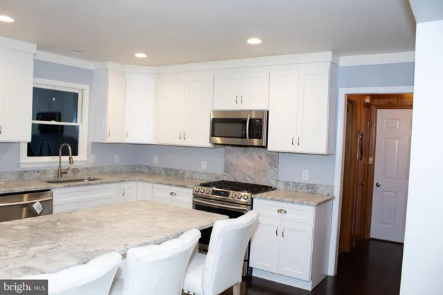 a kitchen with a sink stove and microwave