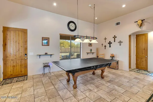 a large living room with lots of furniture and chandelier
