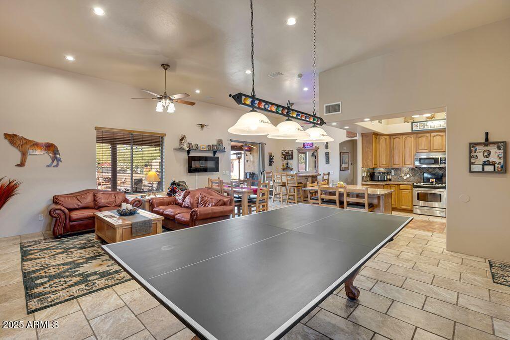 1053 East Maddock Road Phoenix, AZ 85086 - Photo 8 of 60 a large living room with lots of furniture and chandelier