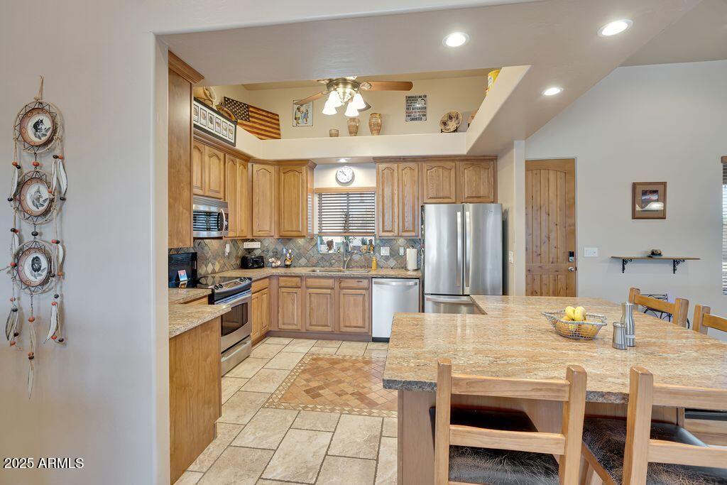 1053 East Maddock Road Phoenix, AZ 85086 - Photo 15 of 60 a large kitchen with a table and chairs