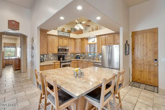 a large kitchen with a table and chairs