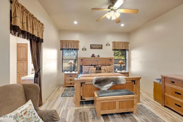 a bedroom with a bed couch and a view of kitchen