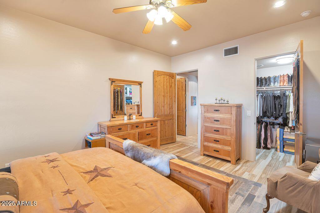 1053 East Maddock Road Phoenix, AZ 85086 - Photo 23 of 60 a bedroom with a bed and a chandelier