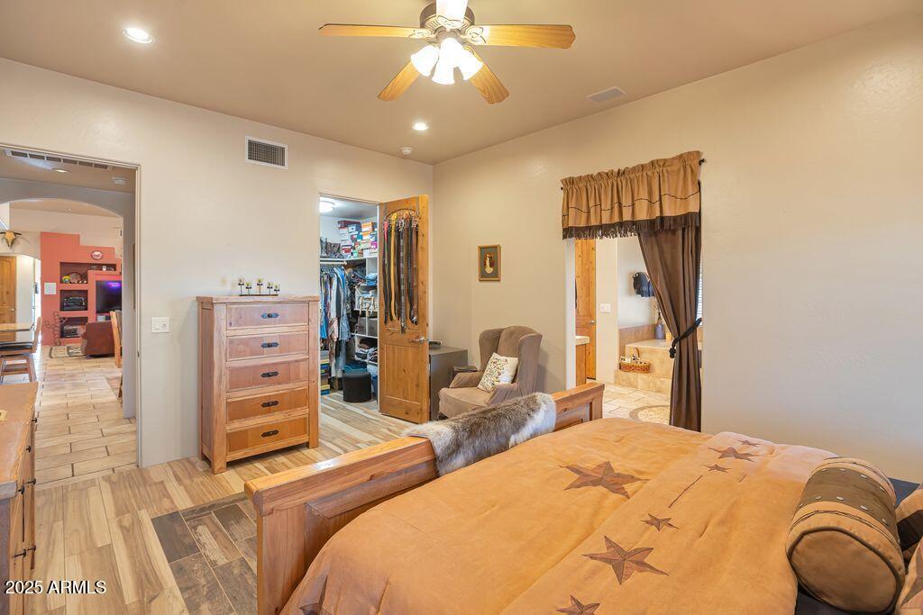 1053 East Maddock Road Phoenix, AZ 85086 - Photo 24 of 60 a bedroom with a bed and a chandelier