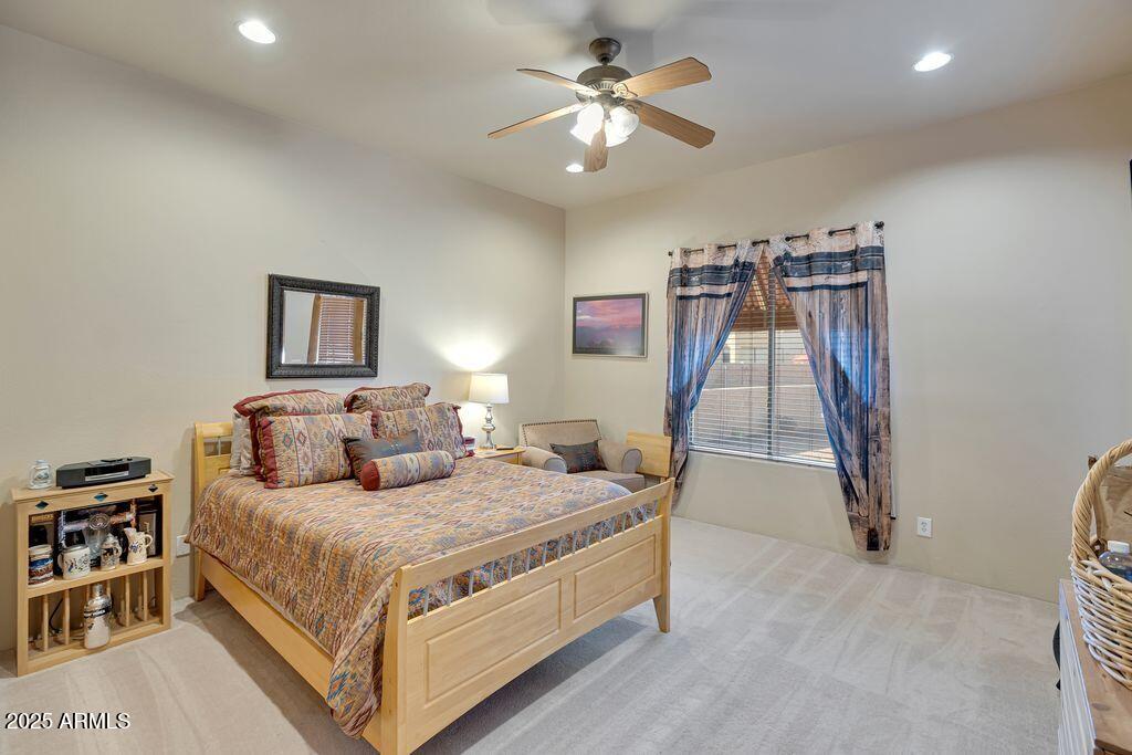 1053 East Maddock Road Phoenix, AZ 85086 - Photo 29 of 60 a bedroom with a bed and a ceiling fan