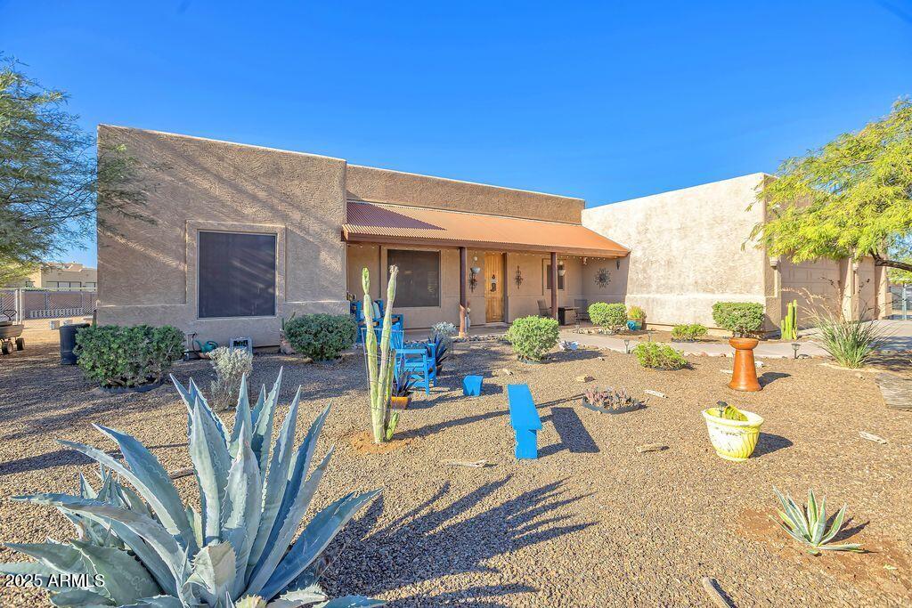 1053 East Maddock Road Phoenix, AZ 85086 - Photo 4 of 60 a view of a patio with couches table and chairs and potted plants