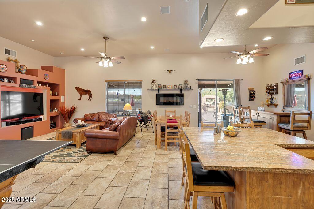 1053 East Maddock Road Phoenix, AZ 85086 - Photo 6 of 60 a living room with furniture a flat screen tv and kitchen view
