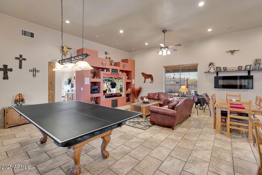 1053 East Maddock Road Phoenix, AZ 85086 - Photo 7 of 60 a living room with furniture a flat screen tv and kitchen view