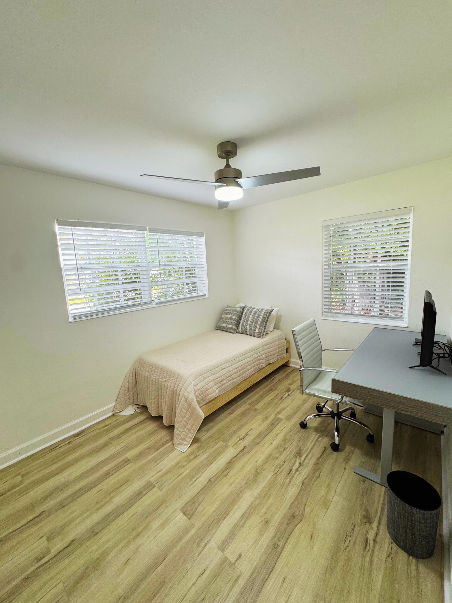 300 Northeast 7th Street Boca Raton, FL 33432 - Photo 11 of 16 a spacious bedroom with a bed a desk and chair