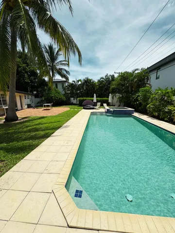 a swimming pool with outdoor seating and yard