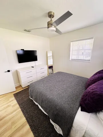 a bedroom with a bed and a flat screen tv