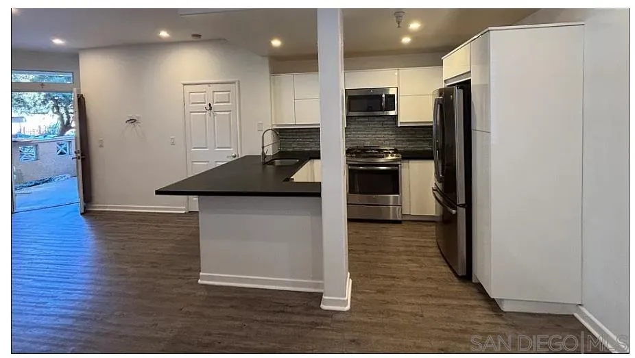 3919 Normal Street San Diego, CA 92103 - Photo 3 of 14 a kitchen with kitchen island stainless steel appliances a refrigerator and a stove