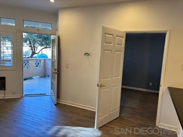 3919 Normal Street San Diego, CA 92103 - Photo 8 of 14 a view of a hallway with wooden floor and a living room