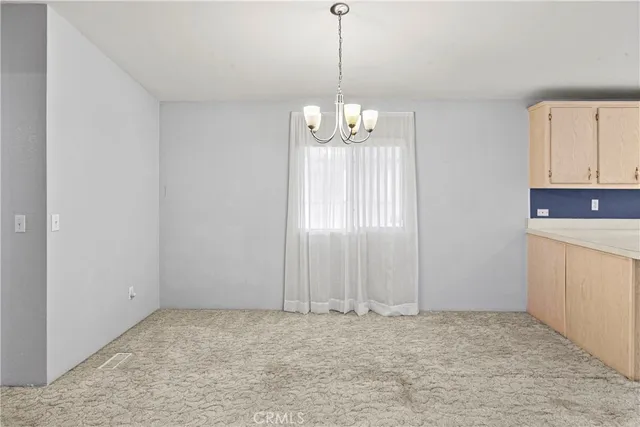 a kitchen with cabinets appliances a sink and a window