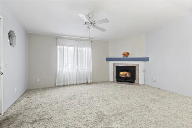 a view of an empty room with a fireplace