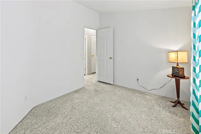 a view of a room with a bench and a window