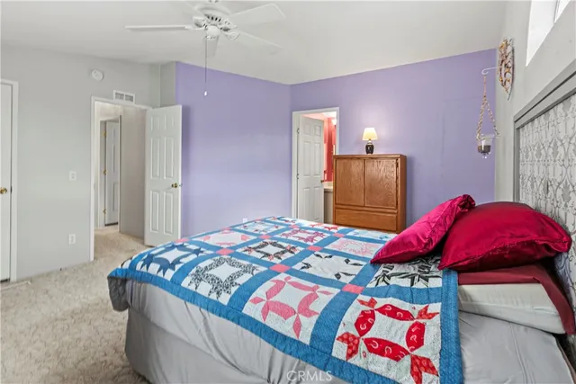 a bedroom with a bed and a mirror