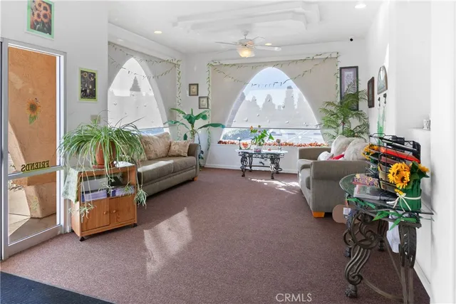 a living room with furniture and a chandelier