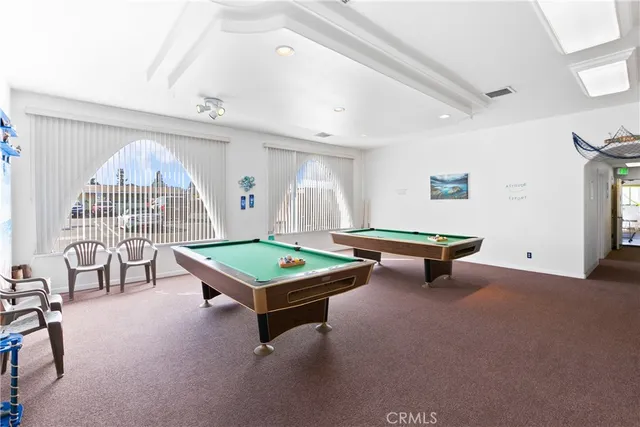 a room with furniture and pool table