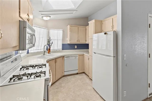 a view of a kitchen with a sink and chandelier