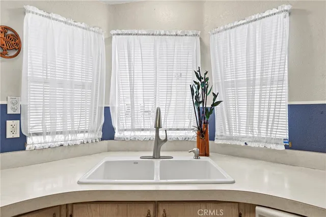 a kitchen with a white cabinets and white appliances