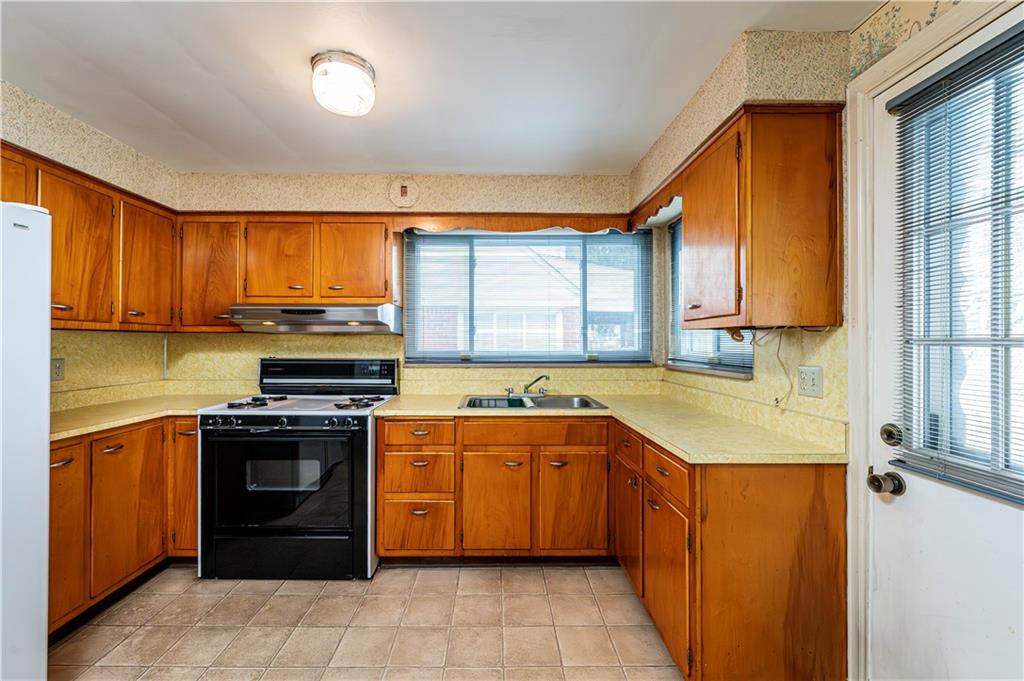 523 Beulah Road Pittsburgh, PA 15235 - Photo 11 of 36 a kitchen with a sink stove top oven and cabinets