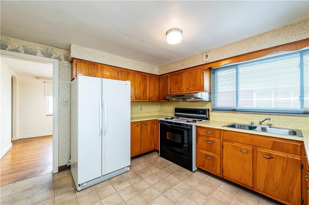 523 Beulah Road Pittsburgh, PA 15235 - Photo 12 of 36 a kitchen with stainless steel appliances granite countertop a refrigerator and a stove top oven