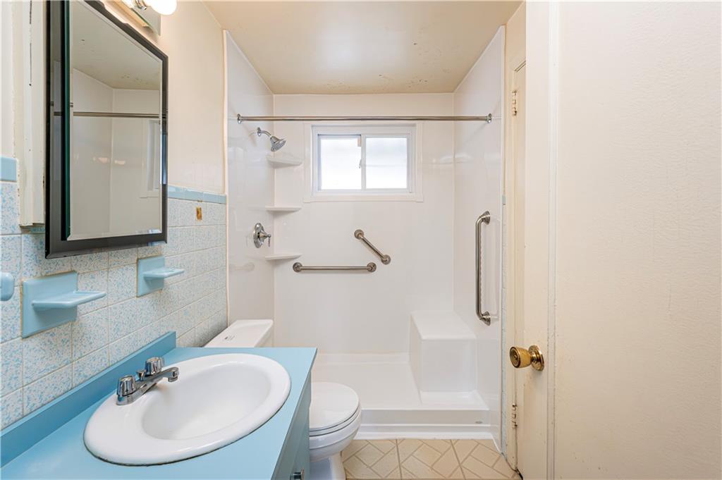 523 Beulah Road Pittsburgh, PA 15235 - Photo 13 of 36 a bathroom with a sink toilet a mirror and shower