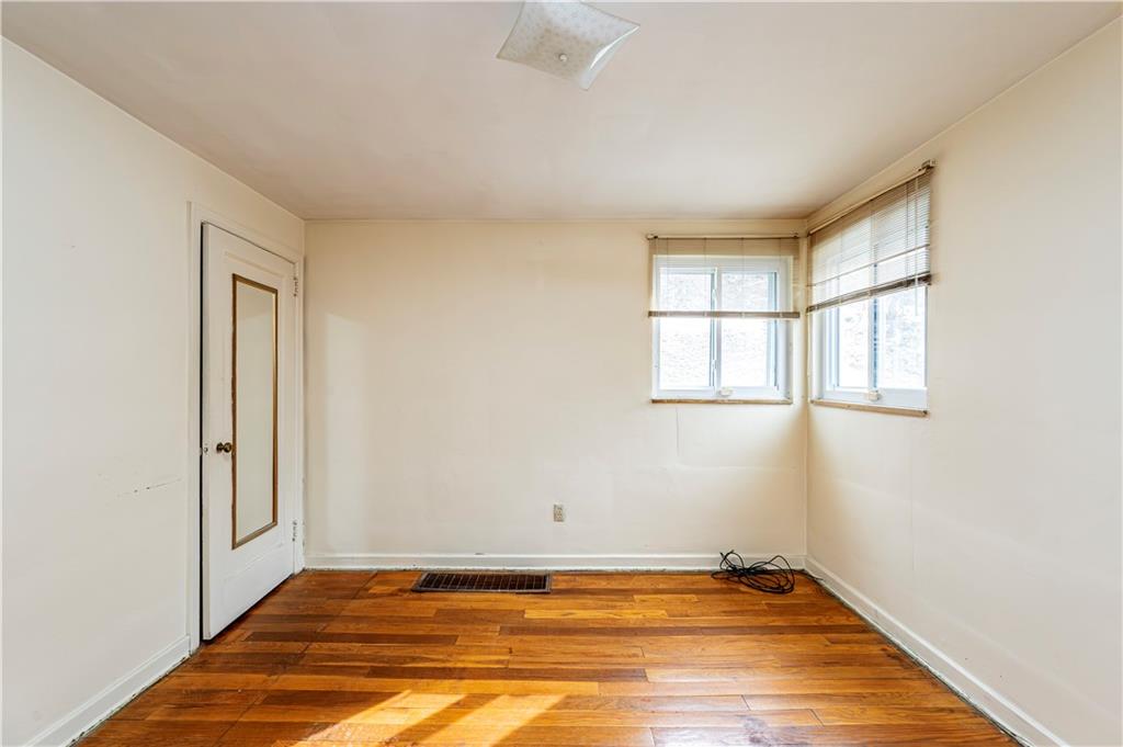523 Beulah Road Pittsburgh, PA 15235 - Photo 15 of 36 a view of empty room with window and wooden floor