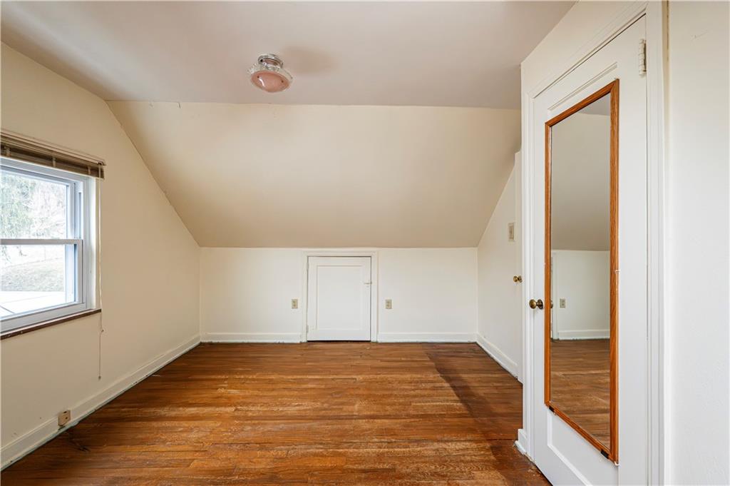 523 Beulah Road Pittsburgh, PA 15235 - Photo 22 of 36 an empty room with an entryway and wooden floor