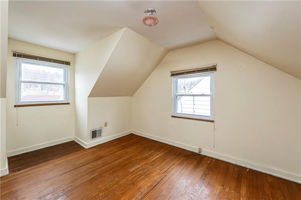 523 Beulah Road Pittsburgh, PA 15235 - Photo 23 of 36 an empty room with wooden floor and windows