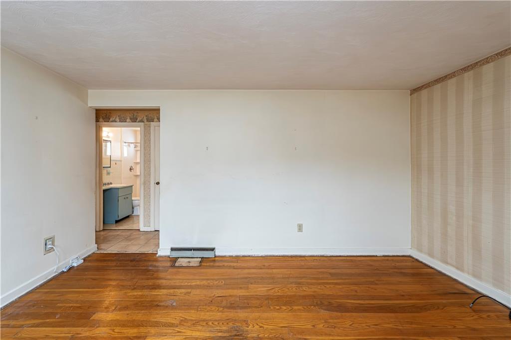 523 Beulah Road Pittsburgh, PA 15235 - Photo 4 of 36 a view of an empty room with wooden floor and a window