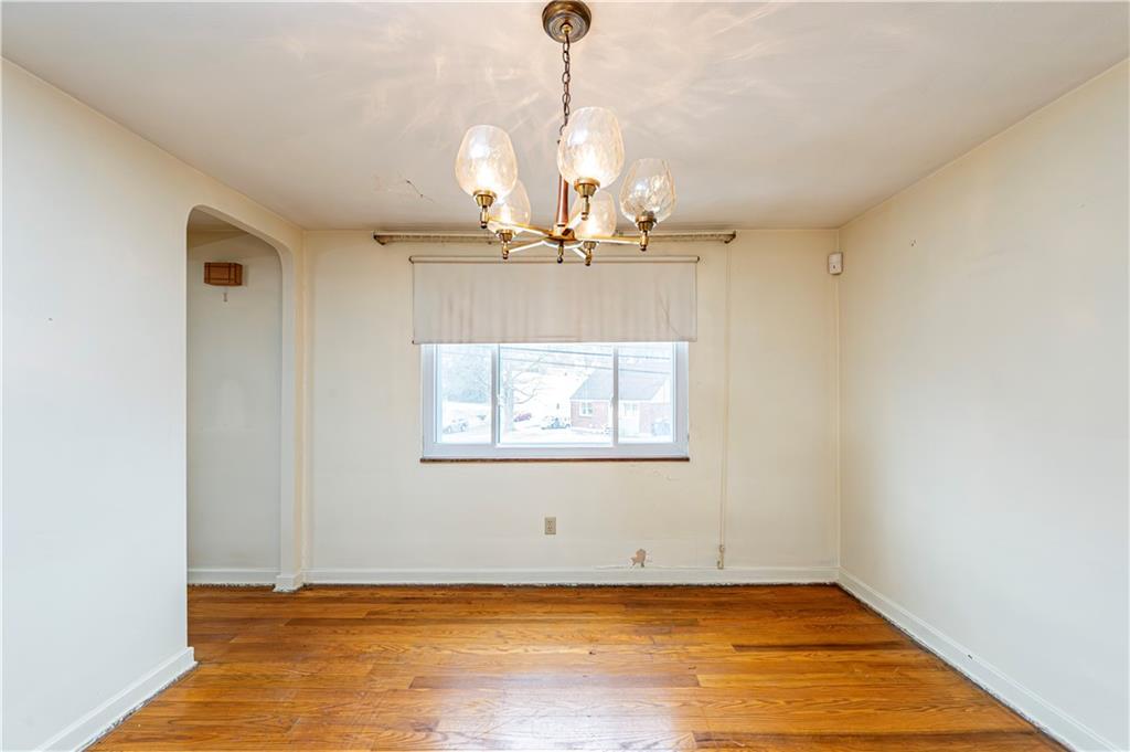 523 Beulah Road Pittsburgh, PA 15235 - Photo 10 of 36 a view of a room with window wooden floor and a chandelier