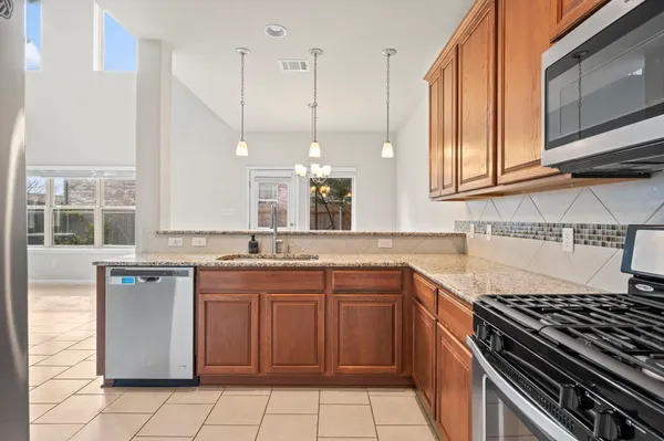 a kitchen with a refrigerator a sink and cabinets