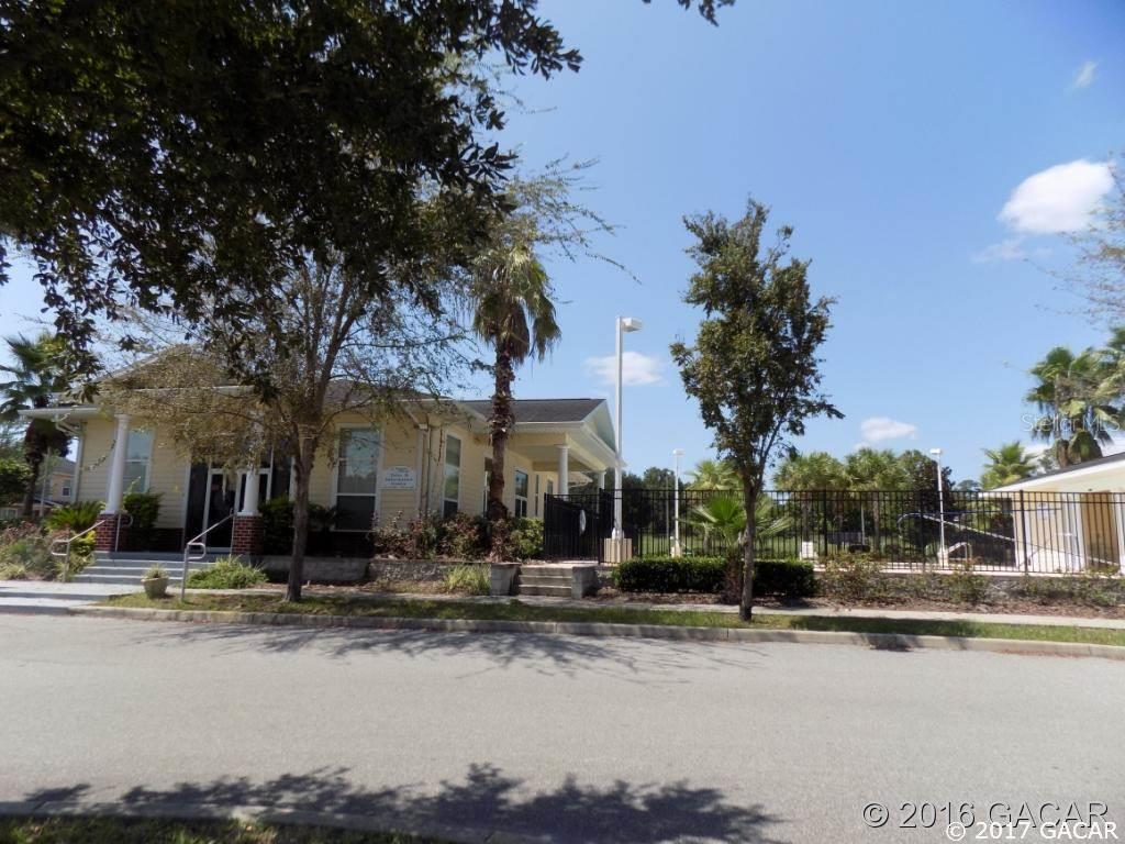 1609 Northwest 29 Road Gainesville, FL 32605 - Photo 1 of 1 a front view of a building with trees around