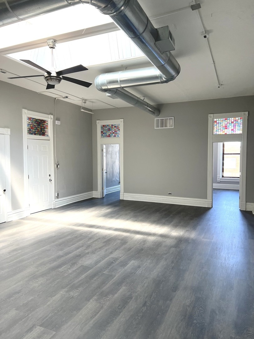 8 North State Street Elgin, IL 60123 - Photo 2 of 9 en empty room with wooden floor and windows