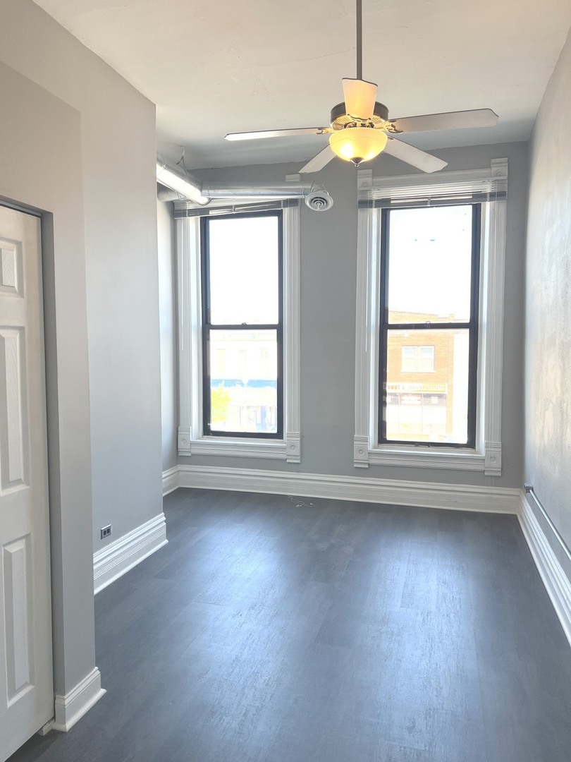 8 North State Street Elgin, IL 60123 - Photo 4 of 9 a view of an empty room with a window
