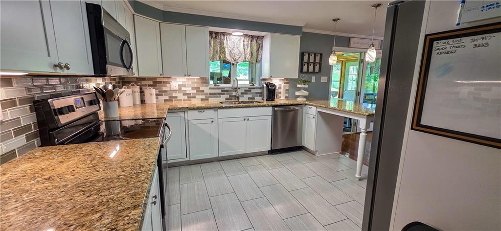 532 Strope Road Burgettstown, PA 15021 - Photo 4 of 20 a kitchen with stainless steel appliances granite countertop a refrigerator and a stove