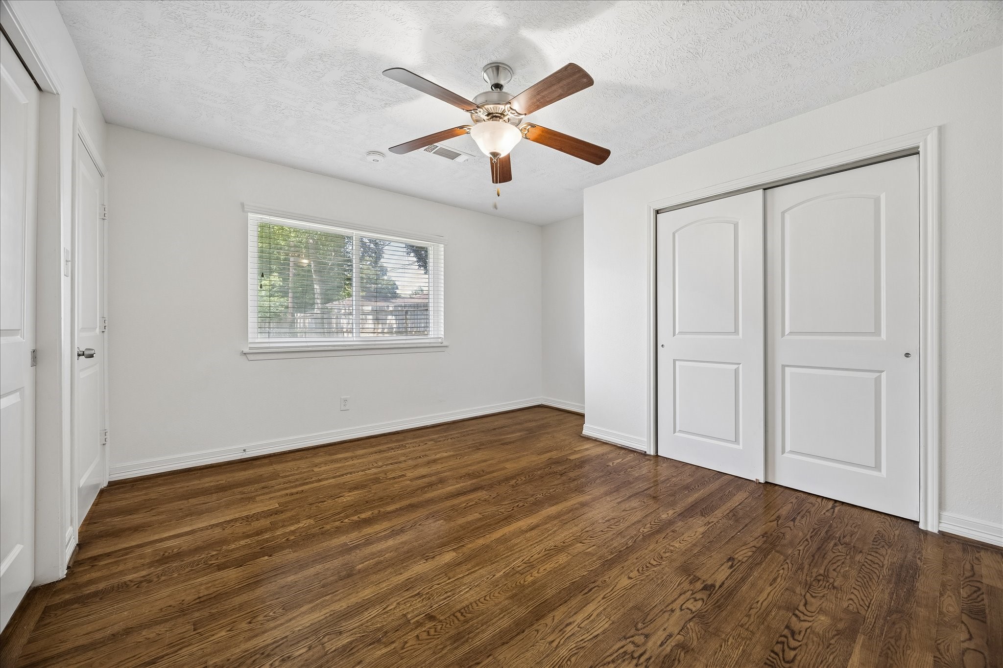 5019 Kinglet Street Houston, TX 77035 - Photo 13 of 24 Another view of first floor secondary bedroom with ceiling fan & green views through upgraded windows.