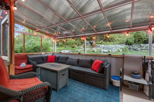 a outdoor living space with furniture and a fireplace