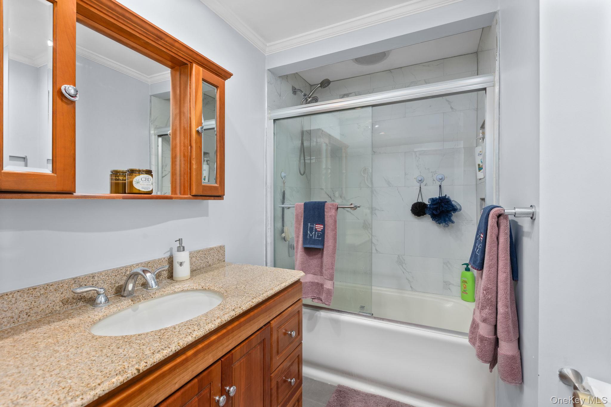 97 Old Road Brewster, NY 10509 - Photo 15 of 23 Bathroom with bath / shower combo with glass door, vanity, and ornamental molding