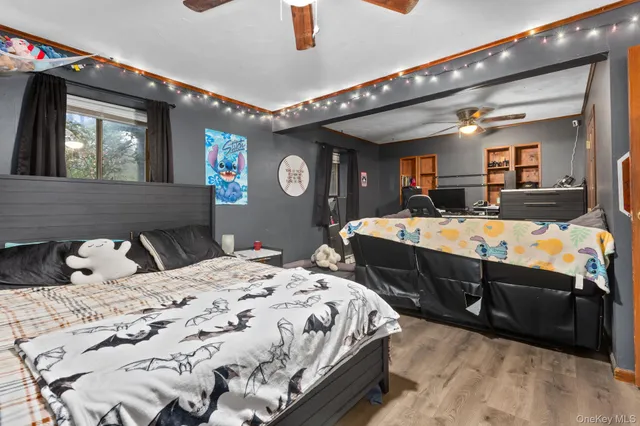 a bedroom with bed and wooden floor