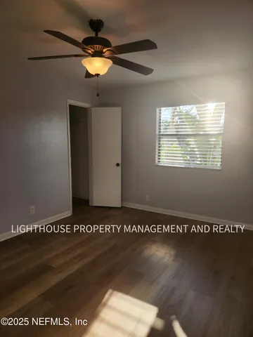 a view of a ceiling fan and wooden floor