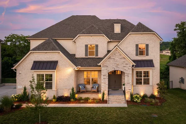 a front view of a house with a yard